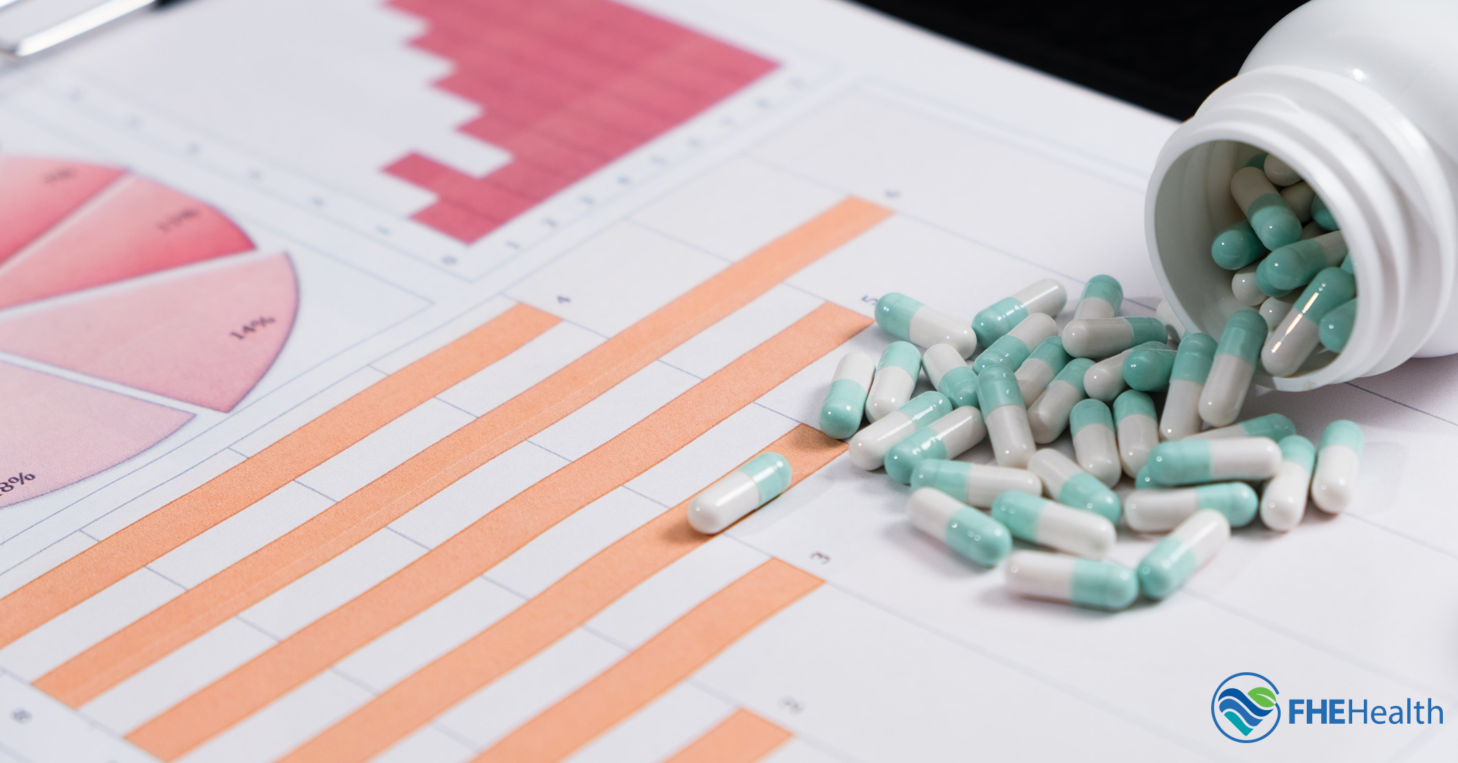 A bottle of pills spilling over a paper showing overdose statistics